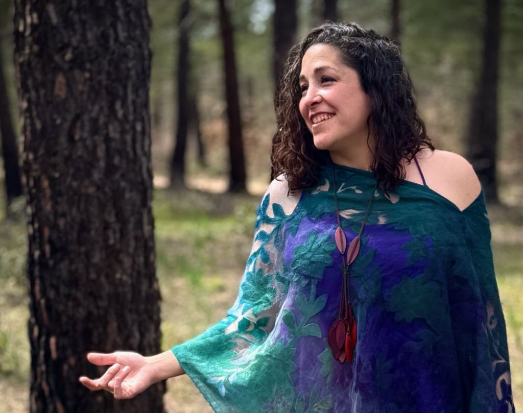 Kerry Robarge, founder of Uncharted Pathways, smiling in a forest